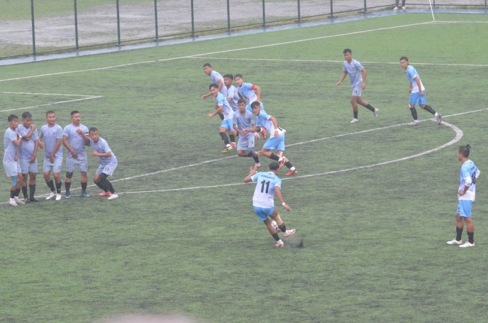 Nyenshen FC players in blue and DEF Tuensang in grey jerseys in a match on October 24 at the 32nd Loyem Memorial Trophy in Tuensang Town. (Morung Photo)